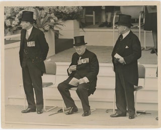 Item #005018 PREMIERS AT THE SALUTING BASE - An original press photograph capturing British Prime...