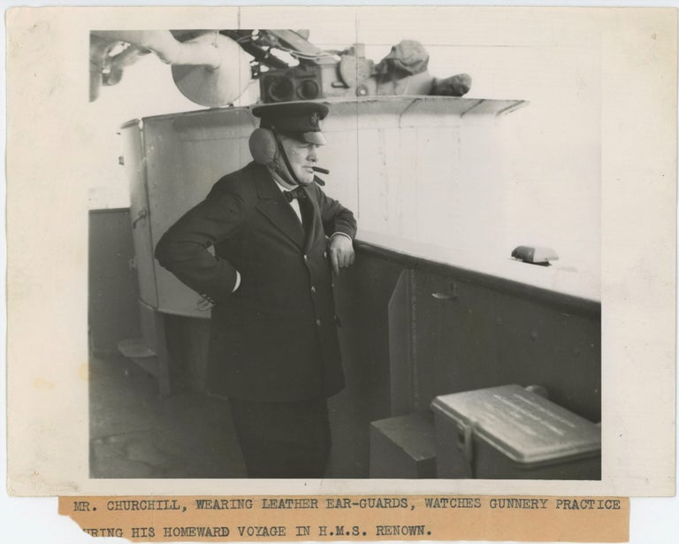 Item #005019 An original wartime press photograph of Prime Minister Winston S. Churchill on 16 September 1943 on board the HMS Renown for his return trip from the first Quebec Conference with President Franklin D. Roosevelt, watching gunnery practice in celebration of his daughter's twenty-first birthday