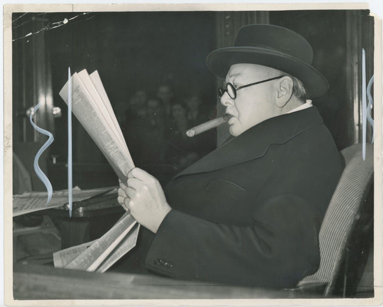 Item #005220 An original press photo of Winston S. Churchill on a train on 23 October 1951 after speaking in support of his son Randolph Churchill for the 1951 General Election which returned Churchill to 10 Downing Street for his second and final premiership three days after this photo was taken
