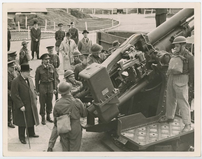 Item #005221 PRIME MINISTER WITH "ACK ACK" GIRLS - An original wartime press photograph of Prime Minister Winston S. Churchill inspecting an anti-aircraft gun and its crew in London on 17 October 1941
