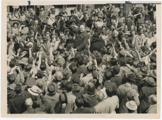 Item #005225 An original wartime press photograph of Prime Minister Winston S. Churchill raising...
