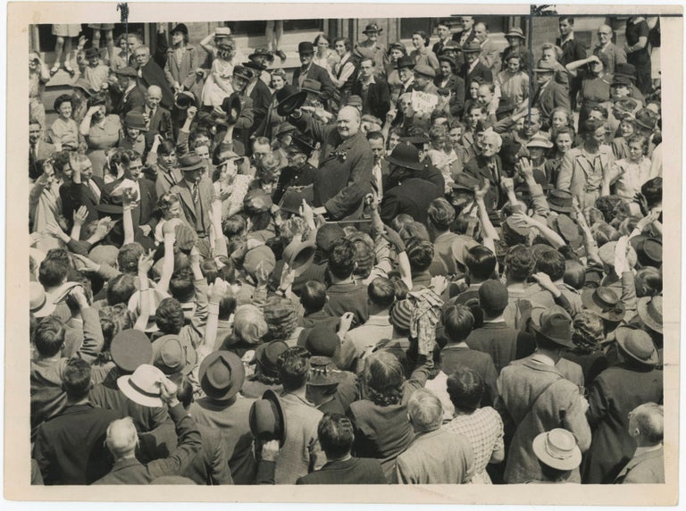 Item #005225 An original wartime press photograph of Prime Minister Winston S. Churchill raising his hat to a crowd during an election tour on 25 June 1945, a month before Labour's landslide General Election victory ended his wartime premiership