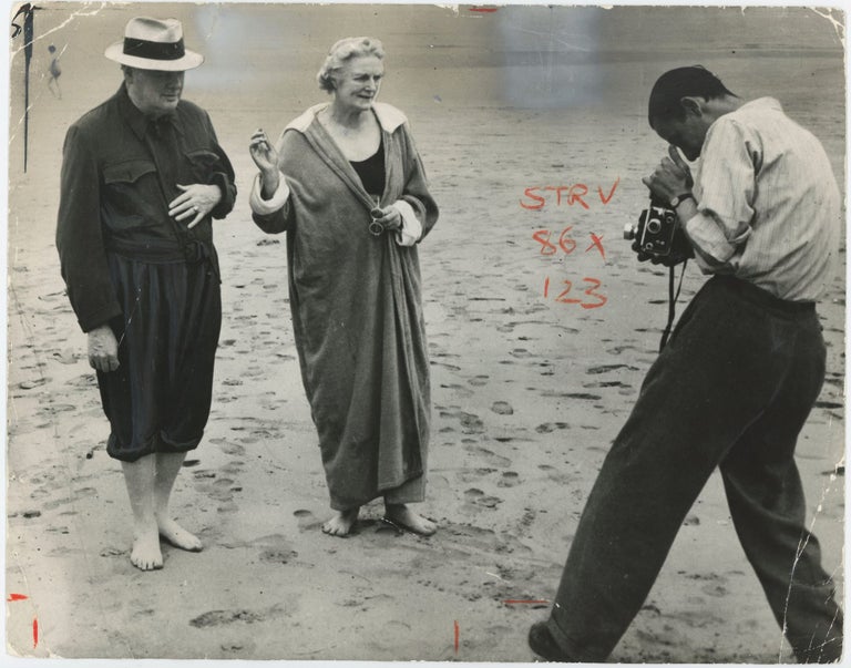 Item #005235 An original press photograph of Winston S. Churchill and Clementine Churchill on the beach at Hendaye, France in July 1945, during General Election polling and just before the final Big Three conference of WWII, enjoying their first days of rest since the start of the war