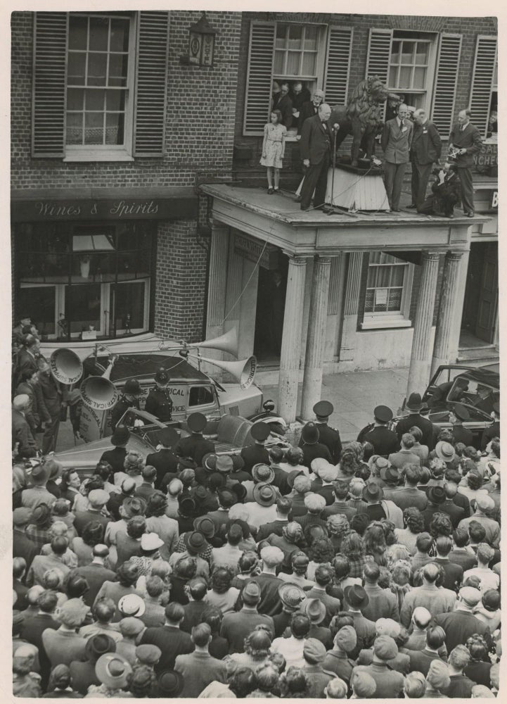 Item #005243 An original wartime press photograph of Prime Minister Winston S. Churchill delivering a campaign speech from a rooftop on 25 June 1945, preparing for the General Election that ended his wartime premiership