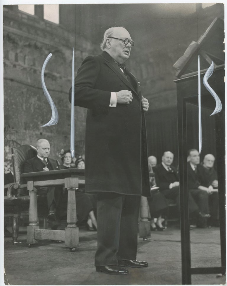 Item #005252 An original press photograph of Winston S. Churchill giving a speech on 3 February 1949 in London's Guildhall after receiving the Grotius Medal in honor of his advocacy for European unity