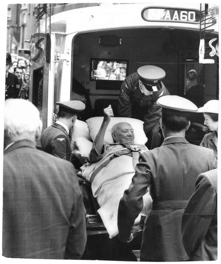 Item #005368 An original press photo of Sir Winston S. Churchill being lifted out of the ambulance at Middlesex Hospital on 29 June 1962, following his fall in Monte Carlo and dramatic return to England via R.A.F. Comet jet on the orders of Prime Minister Harold Macmillan