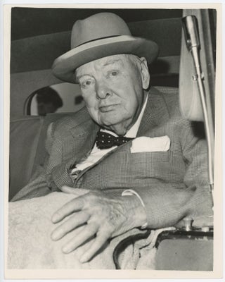 Item #005389 An original press photo of Sir Winston S. Churchill after arrival at London Airport...