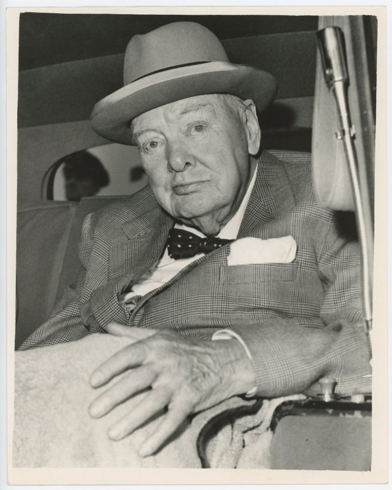 Item #005389 An original press photo of Sir Winston S. Churchill after arrival at London Airport on 4 September 1961, having returned home from a holiday in the south of France