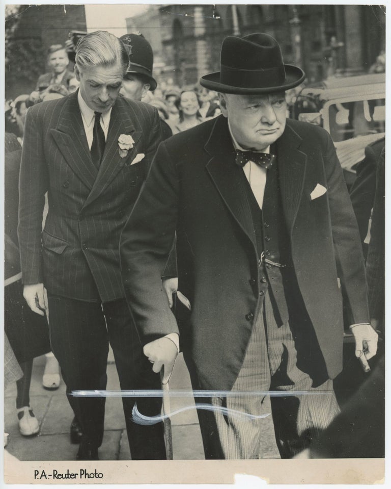 Item #005596 GRAVE FACES IN DOWNING STREET - an original press photograph of Winston S. Churchill and Anthony Eden on 16 August 1950 arriving at 10 Downing Street to meet with Prime Minister Clement Attlee