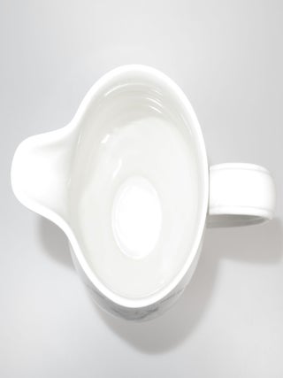 A pitcher originally designed and issued early during the Second World War, featuring an image of and quotes by then-Prime Minister Winston S. Churchill, reissued in this unique form to commemorate Winston Churchill's death in 1965