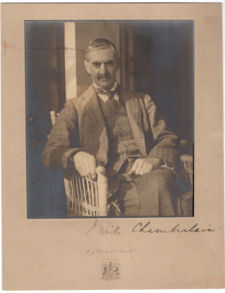 A mounted photographic portrait of Prime Minister Neville Chamberlain, captured by a prominent...